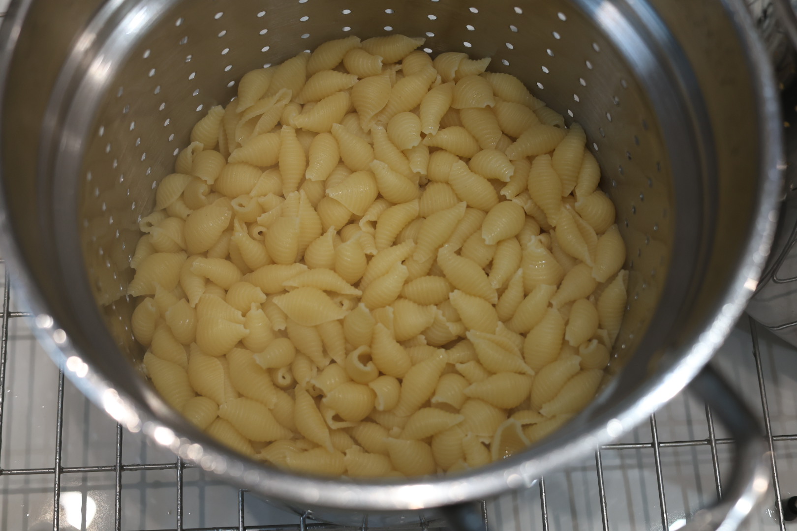 Ultimate Cheesy Beef and Shells Dinner 5 a colander with cooked and drained shell pasta
