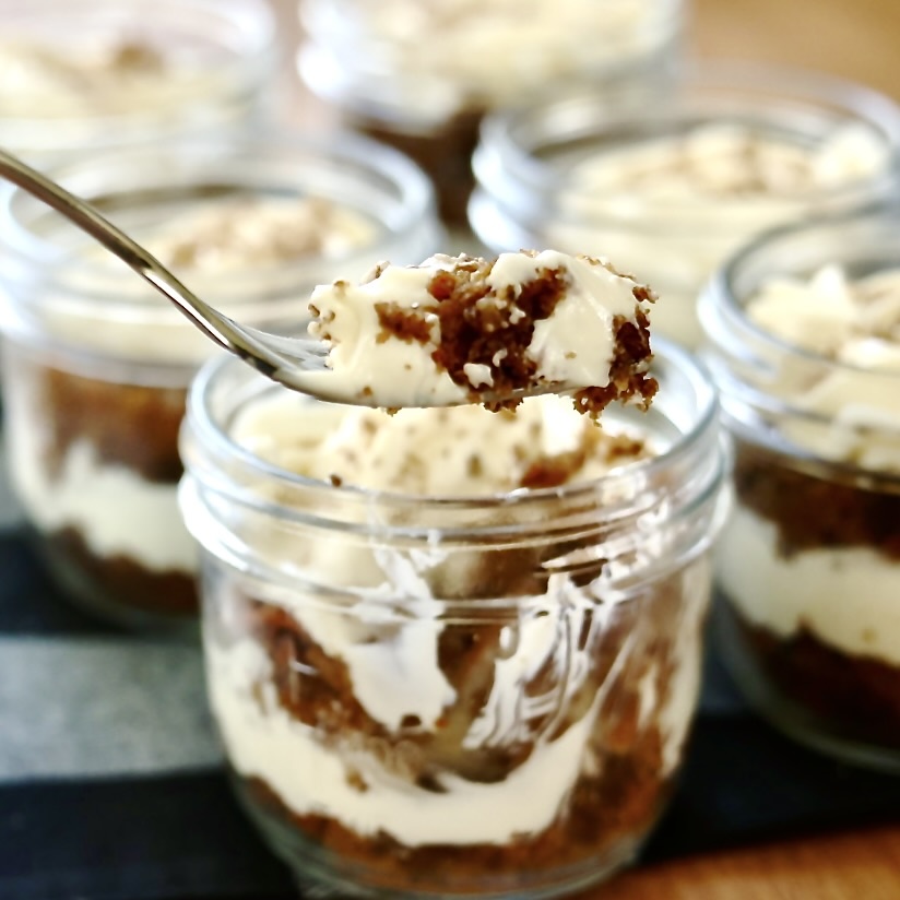 Carrot Cake Trifle Jars (Easy Mason Jar Dessert for Spring & Potlucks) 11 carrot cake trifle jars with a forkful out.