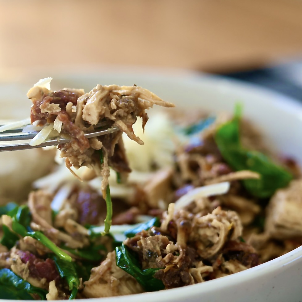 Easy Crockpot Tuscan Chicken (Creamy Slow Cooker Recipe) 2 Crockpot Tuscan Chicken on a fork. close up shot