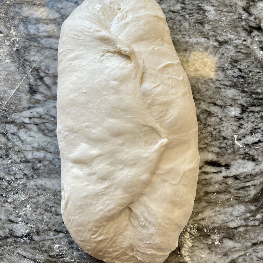 How to Shape Sourdough Bread (Build Tension for Better Oven Spring and Crumb) 7 overlap only enough to stick the seam together