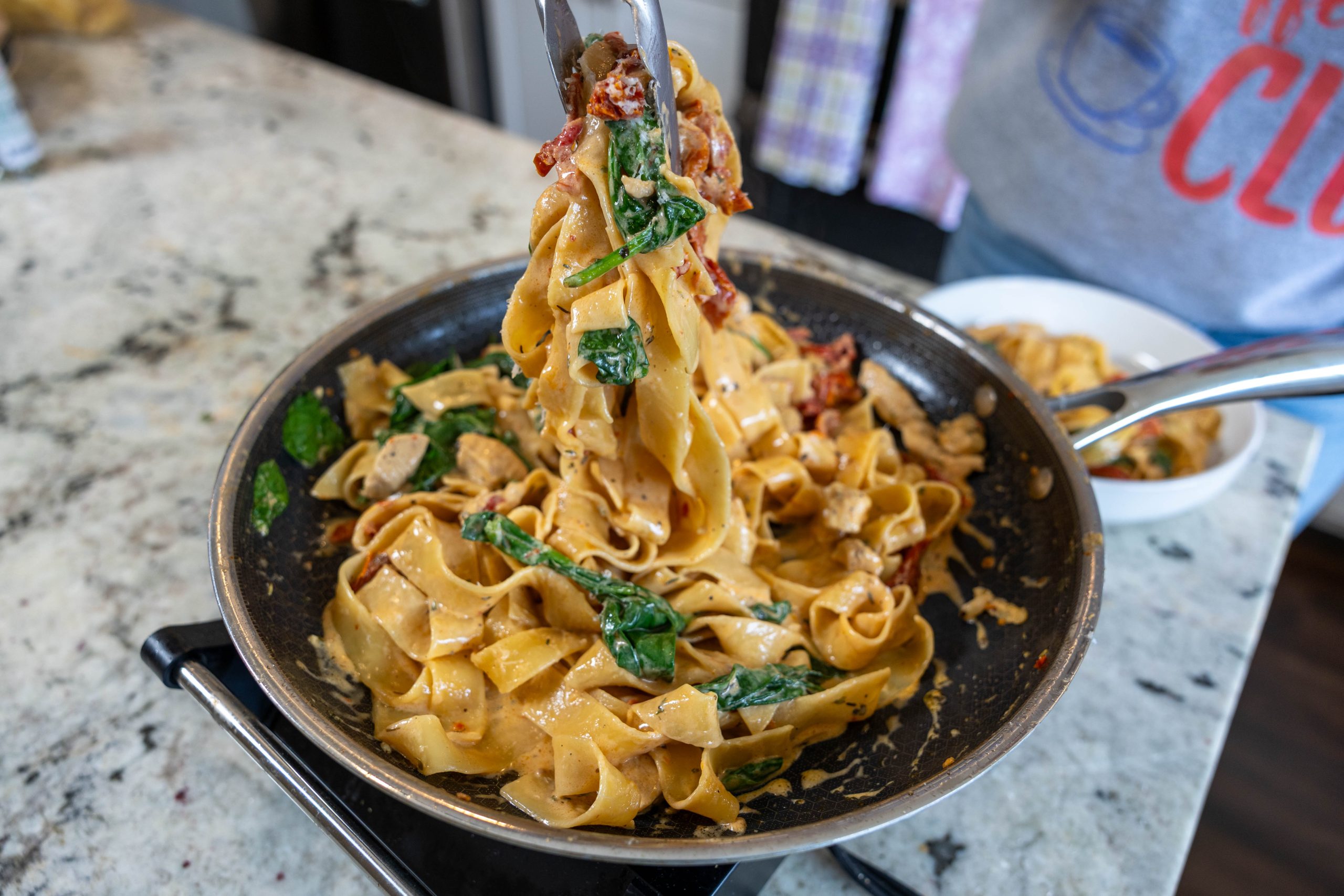 Creamy Garlic Chicken Pasta-Easy One Pan Weeknight Dinner 7 Creamy garlic chicken noodles being pulled from a skillet