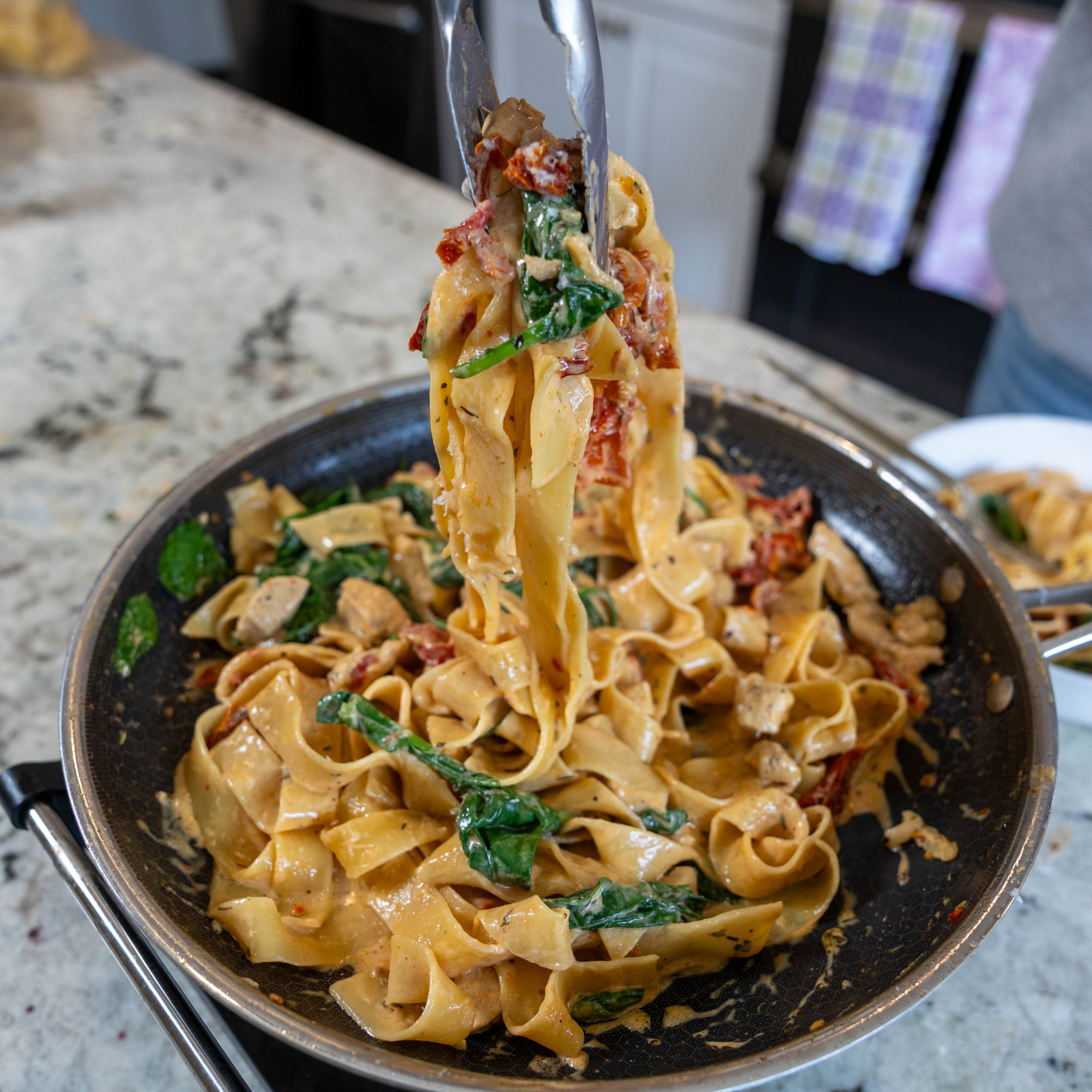 Creamy Garlic Chicken Pasta-Easy One Pan Weeknight Dinner 3 pull shot of creamy garlic chicken noodle dinner from skillet