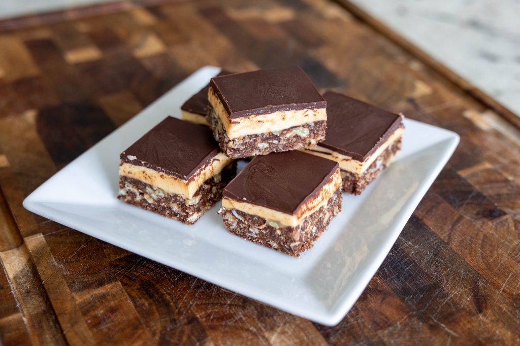 Nanaimo Bars on a plate with one stacked on top