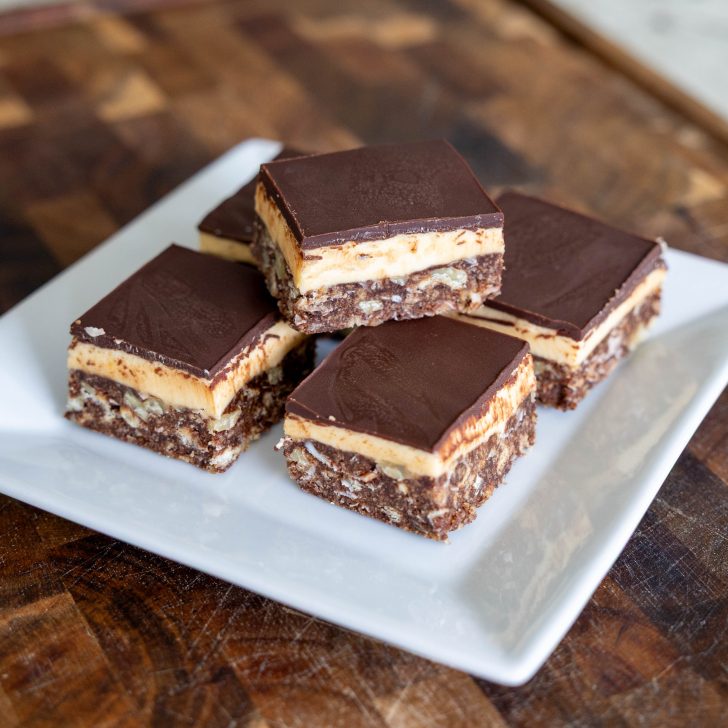 Nanaimo Bars on a plate with one stacked on top