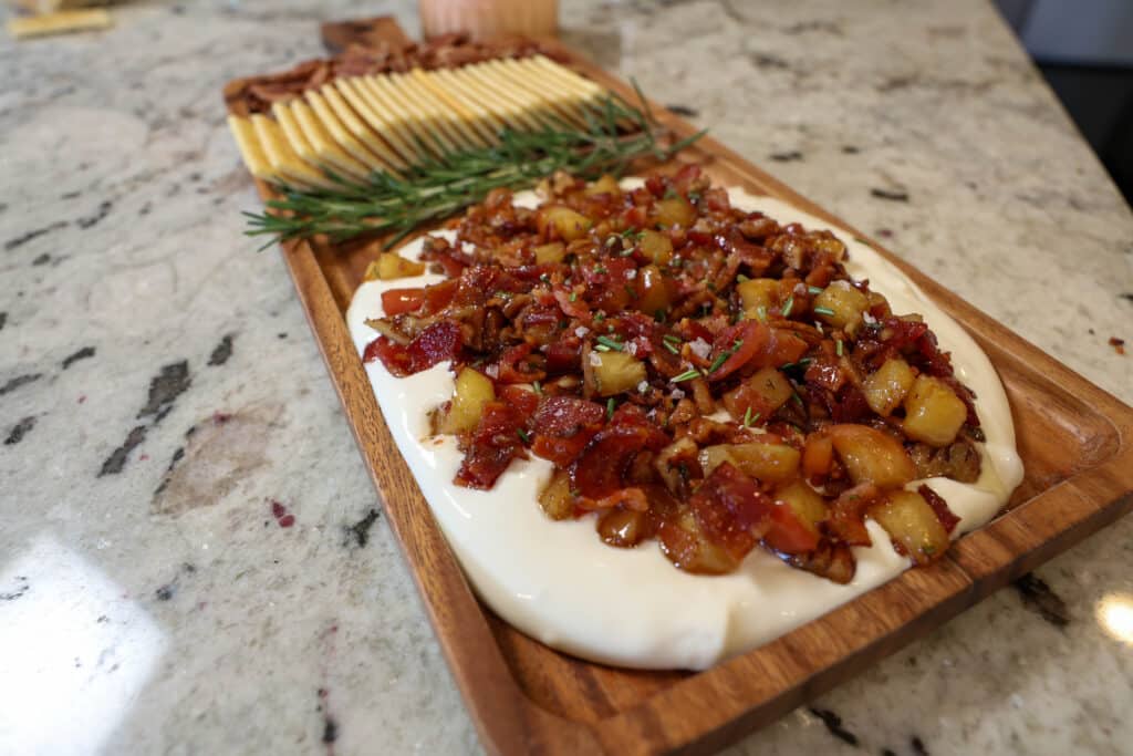 Brown Butter Maple Bacon Whipped Goat Cheese 8 Plated appetizer Maple Bacon Whipped Goat Cheese with rosemary, crackers, and pecans
